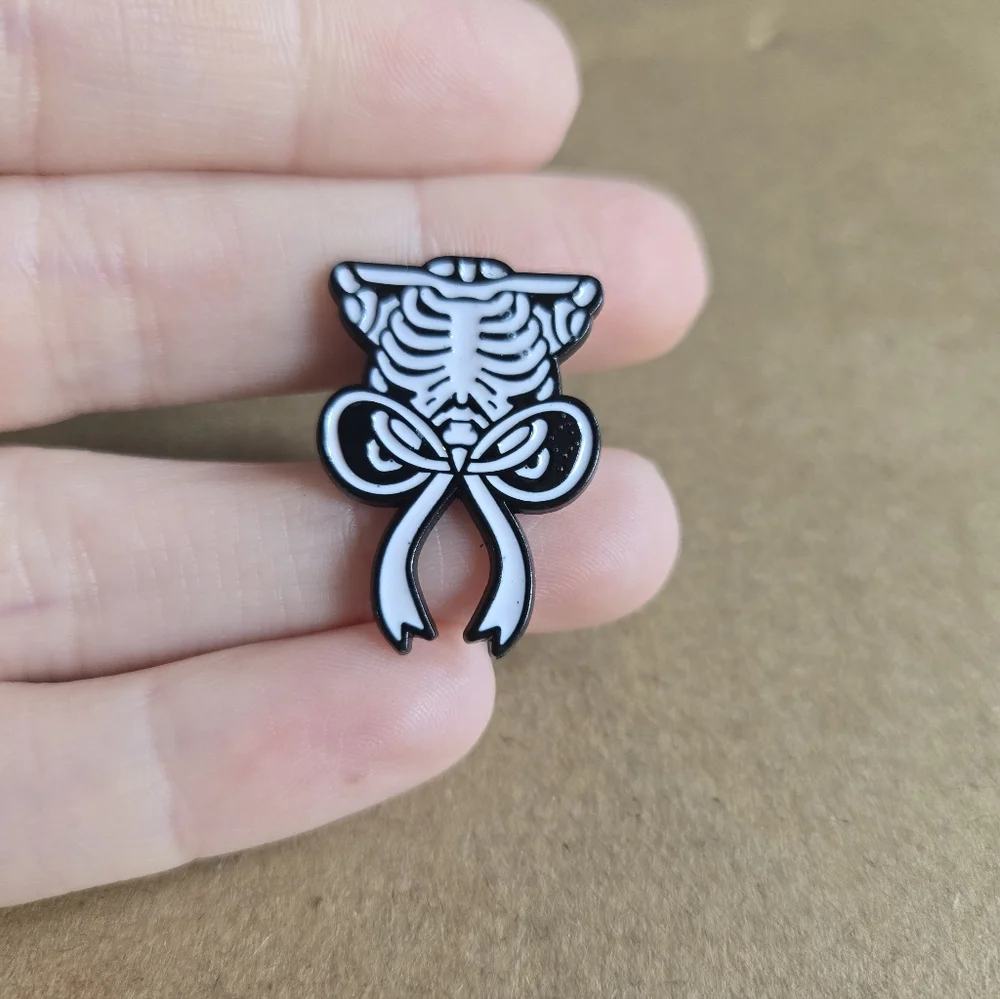 Skeleton Ribcage Bow Enamel Pin